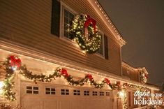 christmas lights are hanging on the side of a house in front of a garage door