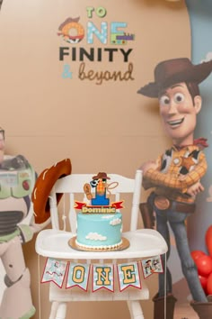 a toy story birthday cake on a chair in front of a wall with cartoon characters