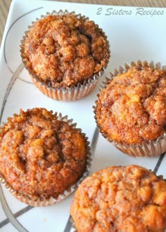 four muffins sitting on top of a white plate