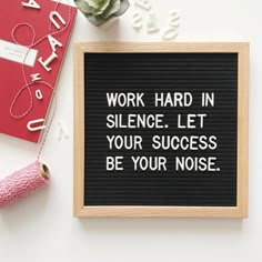 a sign that says work hard in science let your success be your noise next to it