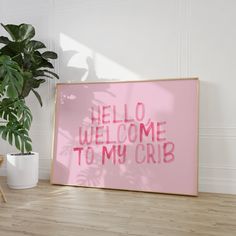 a pink sign that says hello welcome to my crib next to a potted plant