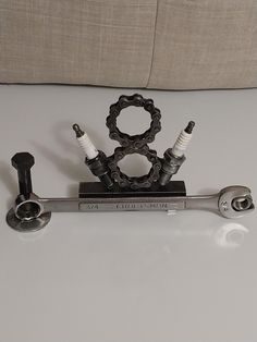 a pair of wrenches sitting on top of a white table next to a pillow