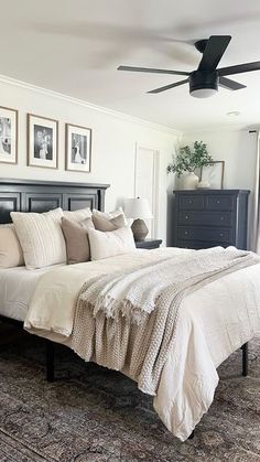 a bedroom with a large bed and pictures on the wall