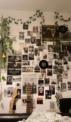 a bedroom wall covered in pictures and plants