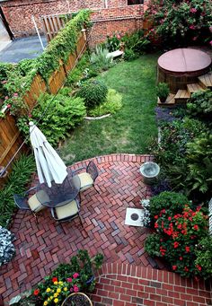 small backyard garden with brick patio and seating area