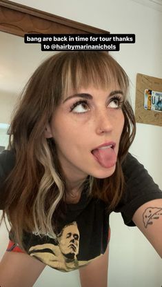 a woman sticking her tongue out in front of the camera with an ad on it