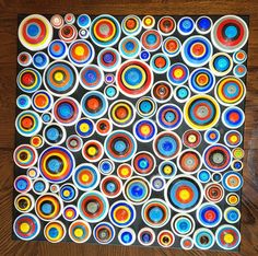 an art work made out of circles on a wooden table