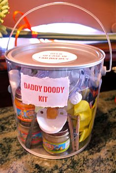 a plastic bucket filled with baby goods on top of a counter