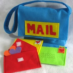 two small bags are sitting next to each other on a white surface, one is blue and the other is red