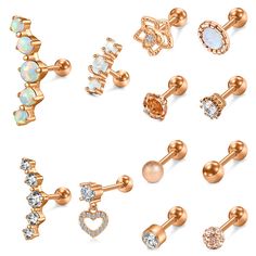 six pairs of studs with different designs and colors on each earring, all in gold