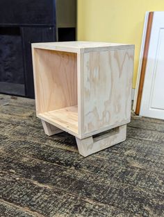 a small wooden box sitting on top of a rug