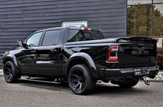 a black truck parked in front of a building