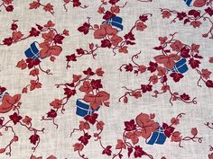 a red and blue fabric with flowers on it