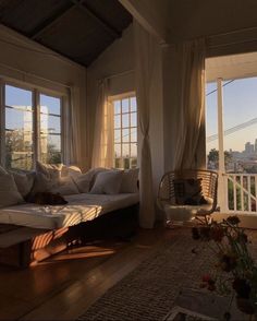 the sun shines through two large windows in this living room