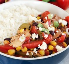 a bowl filled with rice and vegetables next to some tomatoes, peppers, corn on the cob