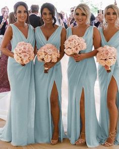 the bridesmaids are all wearing blue dresses and holding bouquets in their hands