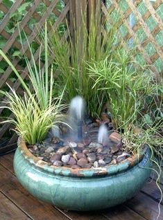 an outdoor fountain in a potted planter filled with water