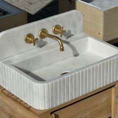 a white sink sitting on top of a wooden box