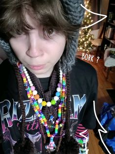 a person wearing a hat with beads on it's neck and the caption says, book?