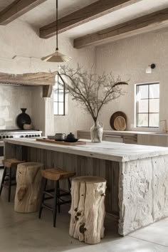 a kitchen with an island and stools in it