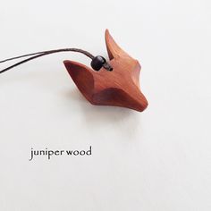 a wooden bird ornament hanging on a string with the words jumper wood written below it