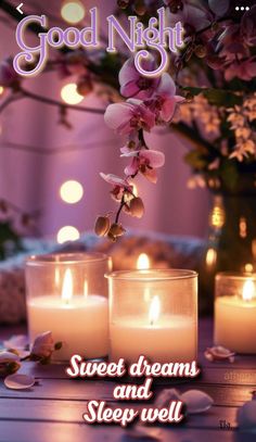 two candles are sitting on a table with flowers in front of them and the words, good night sweet dreams and sleep well