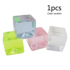 three different colors of plastic cubes on a white background