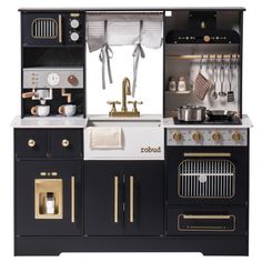 a black and white kitchen with gold trimmings on the oven, stove top and cabinets