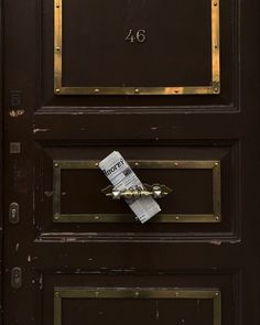 a close up of a door with a mail box on the front and number 46