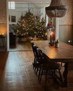 a christmas tree is lit up in the dining room