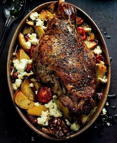 a roasting pan filled with meat and potatoes