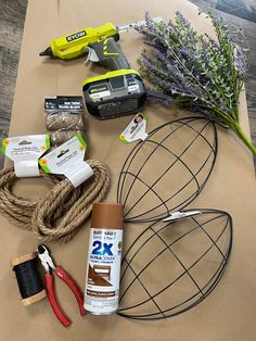 various items are laid out on top of a piece of brown paper with scissors, glue, and twine