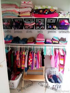 an organized closet with clothes and baskets on the bottom shelf, labeled to organize your child's wardrobe