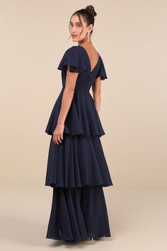 We know that some of your favorite memories will be made while wearing the Lulus Sincerely Exquisite Navy Blue Short Sleeve Tiered Maxi Dress! This timeless dress has an airy woven chiffon composition that shapes a lightly gathered bodice with a surplice neckline and V-back, framed by fluttery short sleeves. The high, fitted waist tops a flowy, tiered A-line skirt that falls to an elegant maxi hem. Hidden back zipper/clasp. Fit: This garment fits true to size. Length: Floor length. Size medium m Blue Flowy A-line Chiffon Dress, Blue A-line Dress With Flowy Skirt, Flowy Tiered Chiffon Dress For Evening, Flowy Tiered Chiffon Evening Dress, Blue Chiffon Maxi Dress For Wedding Guest, Tiered Chiffon Evening Dress, Blue Flowy Chiffon Dress, Blue Ruffled Maxi Dress For Wedding Guest, Flowy Tiered Evening Dress