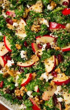 a salad with apples, kale and feta cheese