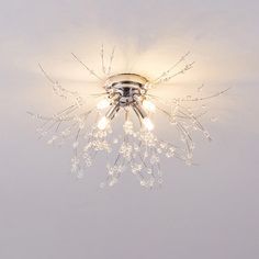 a chandelier with several lights hanging from it's center point on the ceiling