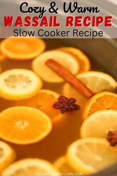 a pot filled with oranges and cinnamon sitting on top of a stove