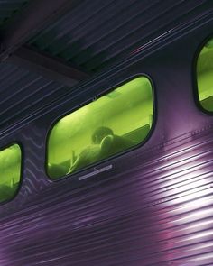 two people are seen through the windows of a train