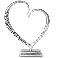 a silver heart shaped trophy with an inscription on the front and bottom that reads,'i love you more than years '