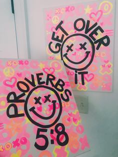 two pink posters with smiley faces and the words prove it in black on each one