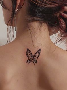 a woman with a butterfly tattoo on her back