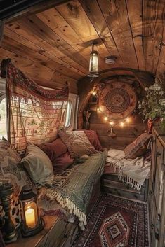 the interior of a small cabin is decorated in wood and has lights hanging from the ceiling