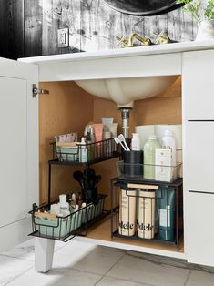 an open cabinet with lots of bathroom items in the bottom shelf and on top of it is a sink