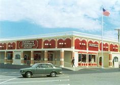 a red and white building with cars parked in front