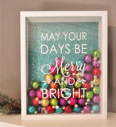 a white frame with christmas ornaments in it and the words may your days be merry and bright