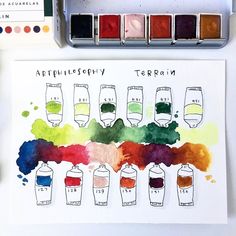 an artist's watercolor palette with different colors on it