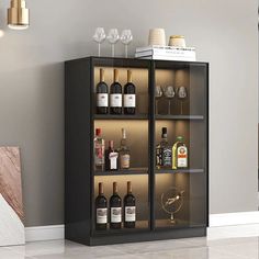 a cabinet with wine glasses and bottles in it