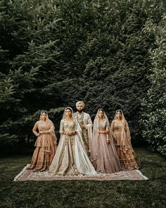 the bride and grooms pose for a photo in front of some trees