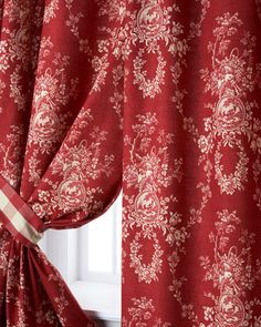 a red curtain with white flowers on it