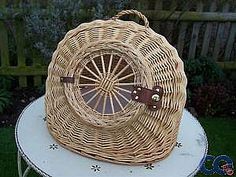 a wicker basket sitting on top of a table in the grass next to a fence